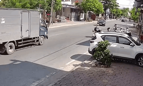Xe tải chạy bạt mạng, oằn mình tránh ôtô rẽ trái