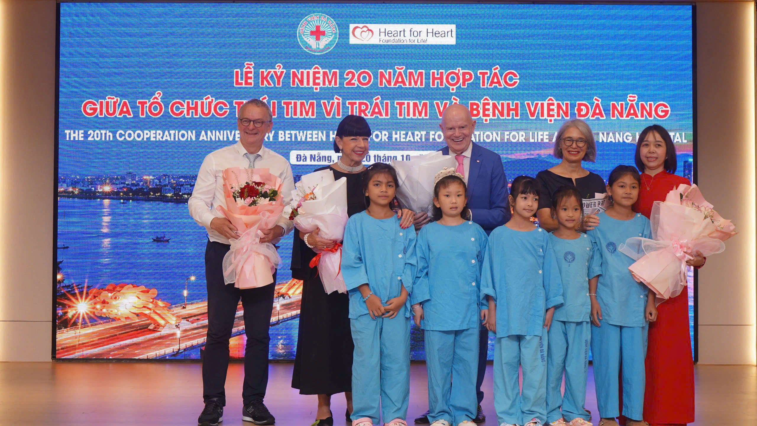 Đại diện Tổ chức Trái tim vì trái tim nhận hoa cảm ơn từ trẻ em Việt Nam - Ảnh: M PHƯƠNG