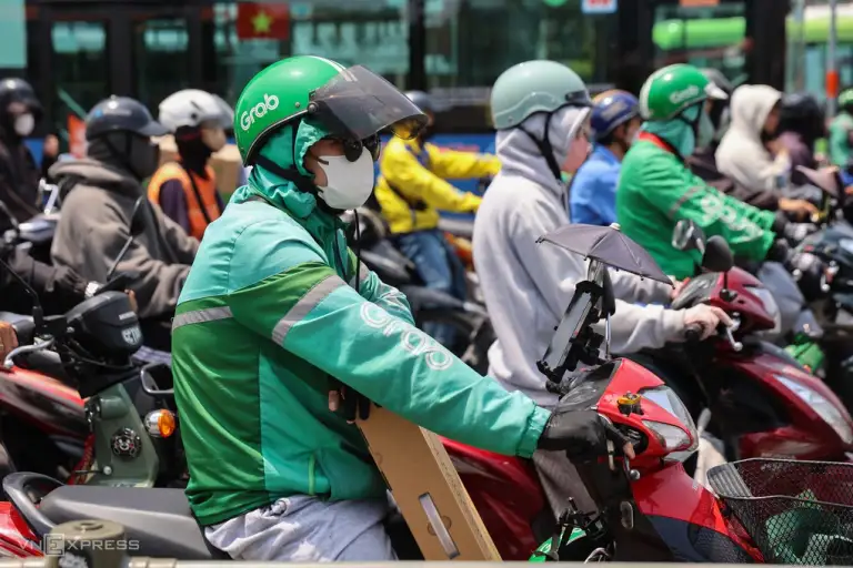 Tài xế xe ôm công nghệ dừng đợi xe tại giao lộ ở trung tâm TP HCM, tháng 4/2026. Ảnh: Quỳnh Trần