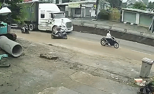 Người đi xe máy đồng loạt ngã, suýt mất mạng cạnh xe container